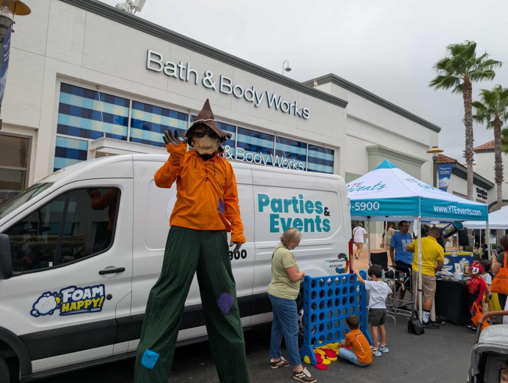 halloween-scarecrow-waving-stilt-walker-yte-events-van-candy-crawl-event