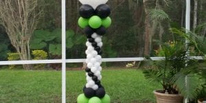 green and black balloon column by the pool