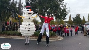 strolling balloon entertainer and stilt walker for winter event nutcracker and snowman