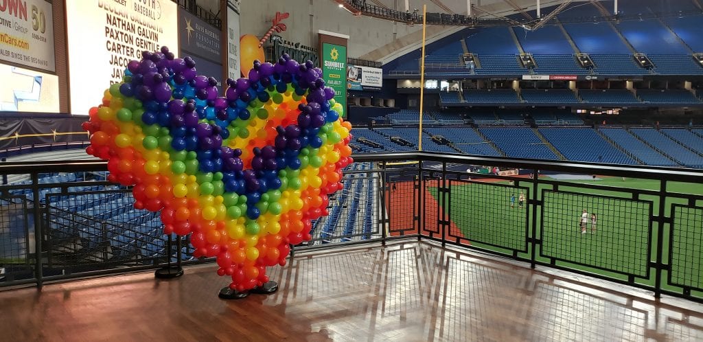 Rainbow Heart of balloons with Rays stadium in background