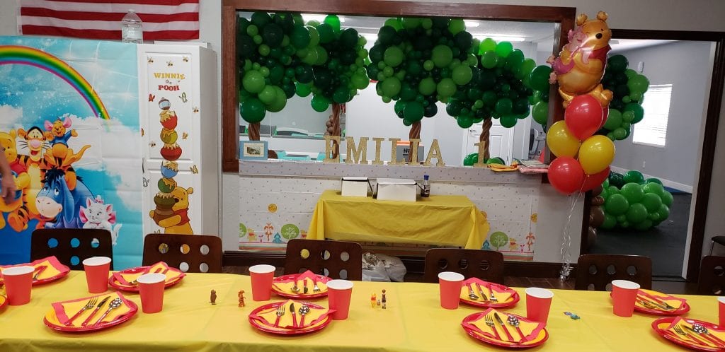 Pooh themed balloon decor for first birthday party