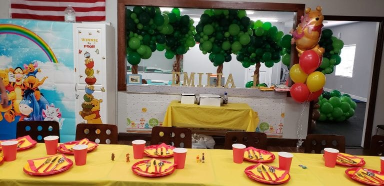 Winnie the Pooh themed balloon decor for a first birthday party