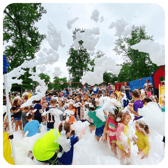 Little ones adorned with foam hats and bubble beards, painting a picture of innocent fun under a soft rain of foam, courtesy of our high-quality foam machine rental.
