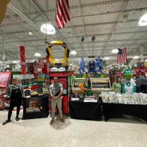 tables setup for entertainers and promo event goody bag items at a publix grocery store