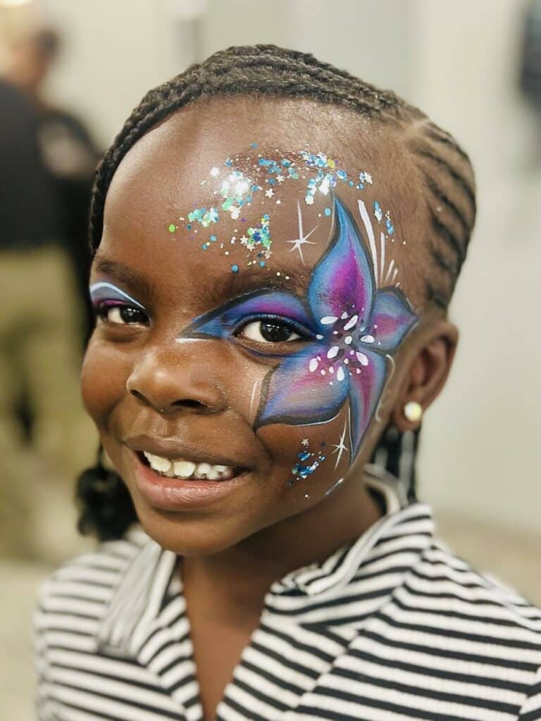 Boys-and-girls-club-guest-face-painted-with-flower-and-glitter