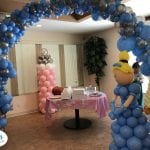 Cinderella themed baby shower event with prince and princess and organic balloon arch silver and blue
