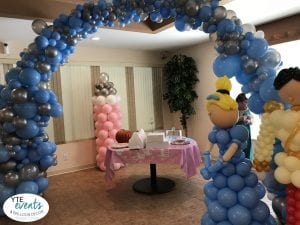 Cinderella themed baby shower event with prince and princess and organic balloon arch silver and blue
