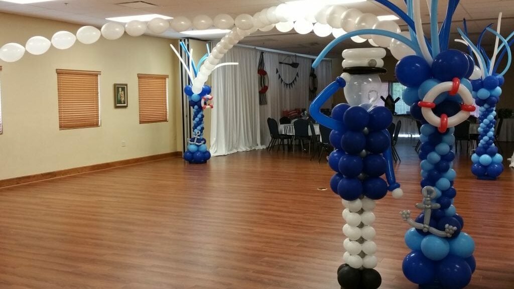 Air Filled Balloon Decor vs. Helium with image of helium links over dance floor and air filled balloon decor in columns and in sculpture in foreground.