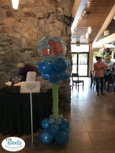 We found Nemo! YTE Events & Balloon Decor loves Disney. We get asked a lot to do something Disney oriented to make this Finding Nemo themed baby shower extra special and fun for not only children, but also adults who have “Disney fever”. For this event at a local restaurant, decorations needed to be easy to move, take down, and not damage the inside. Our balloon twisters decided on a column in ocean blue colors. The marble blues of the bigger balloons gave it a feel of moving ocean currents. The smaller, light blue balloons gave a feel of bubbles. The stem was a light green twisting to the top where Nemo sat. Nemo was definitely the star of the show and having a clear balloon made it seem he was swimming at the top of the column. 	Balloon columns are a great way to add decoration to any event, but especially at events where decorations are limited to rules and regulations, such as restaurants, cafés, or reception halls. Cartoon character toppers can be customized to fit your event including superheroes, princesses, other Disney characters, or just simple colors. Book YTE Events & Balloon Decor and any location can be made into a fun and inviting place for your guests and event! 
