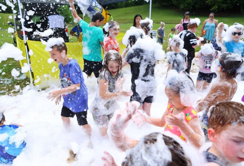 Foam party photo of happy kids at an event