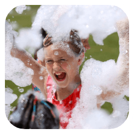 The foam machine conjures a bubbly realm where children leap and dance, each bubble pop marking a moment of unadulterated joy.
