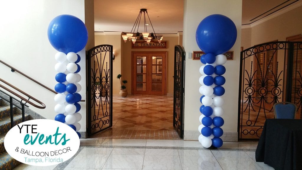 Fun and interesting balloon columns with slow spiral square back bases and blue latex toppers