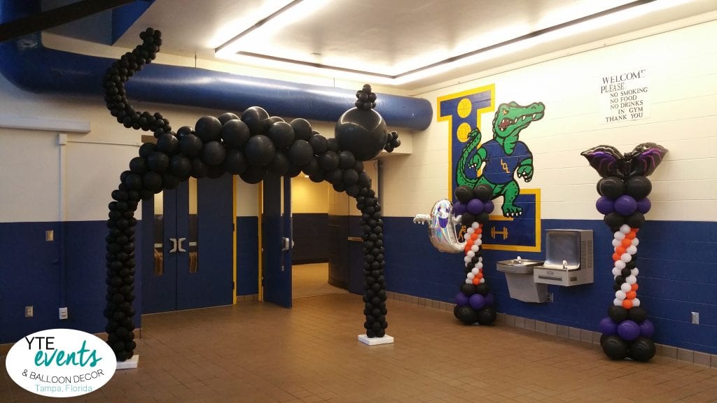 Halloween themed homecoming dance entrance with columns and cat arch