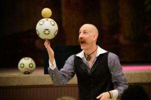 Juggling soccer balls at event with Bill Berry Entertainment