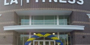 LA Fitness Balloon Decorations with blue and yellow arch
