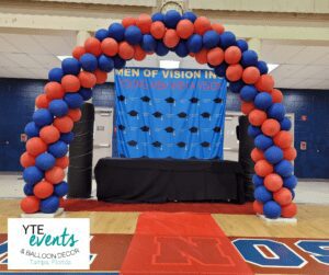 Leadership academy graduation featuring a balloon arch in school colors.
