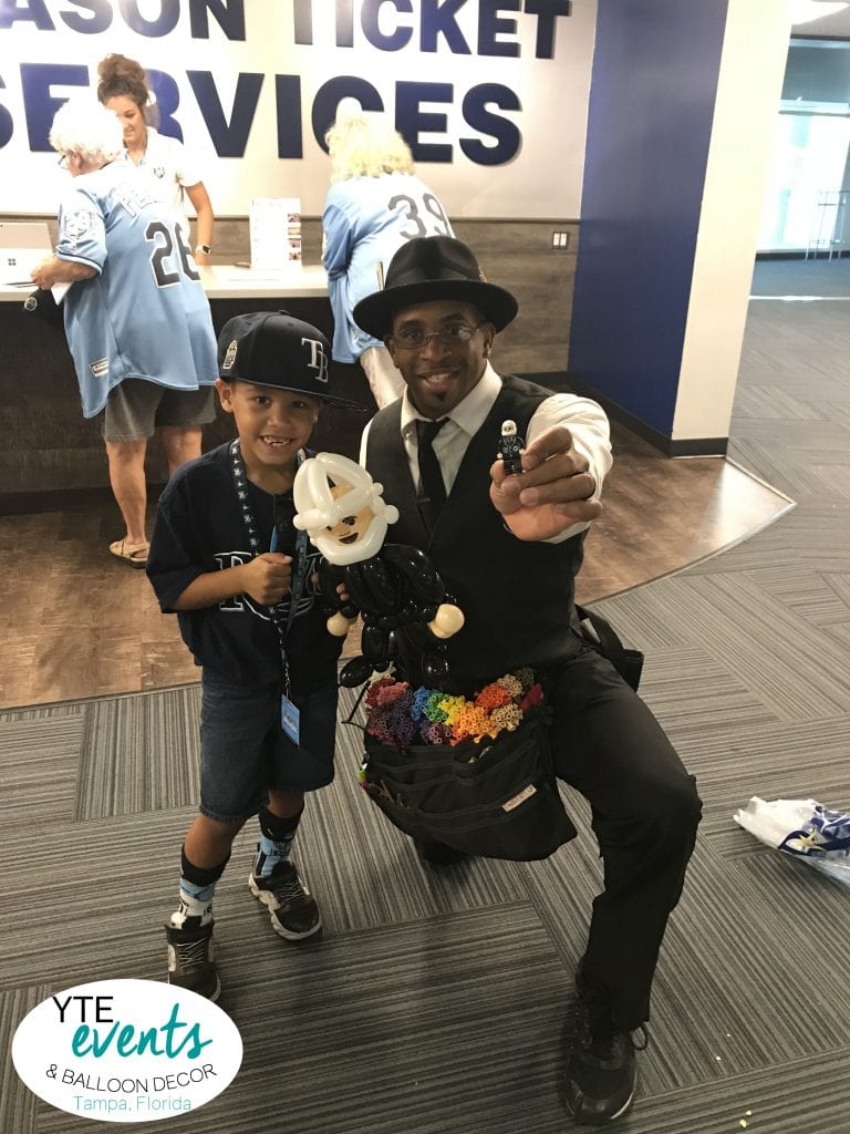 Master Balloon Artist makes a lego man out of balloons at the Tampa Bay Rays Game