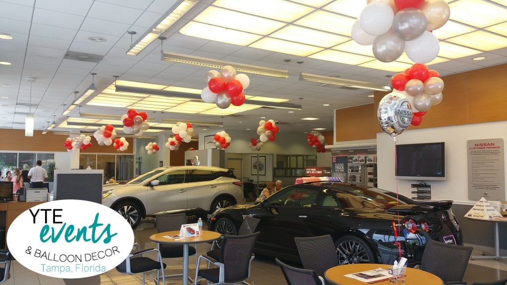 Balloon Columns for Car Dealerships and balloon topiaries on the ceiling. 