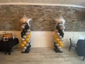 Pair of balloon columns with silver star toppers scaled