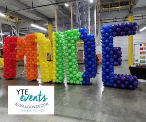 Pride balloon sculpture using rainbow balloons to create each separate letter for Amazon in Ruskin, FL.