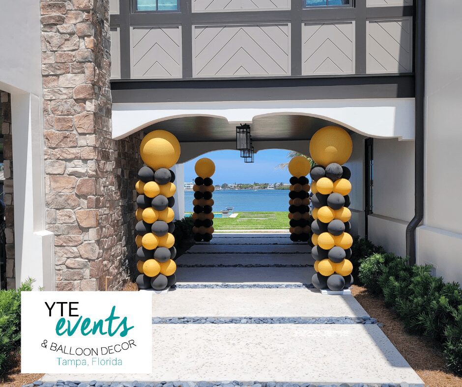 Private graduation event that had yellow and black balloon columns.
