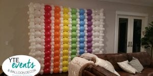 Rainbow balloon wall decorations for private birthday party