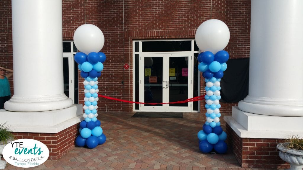 Sculpted blue and white columns for ribbon cutting event