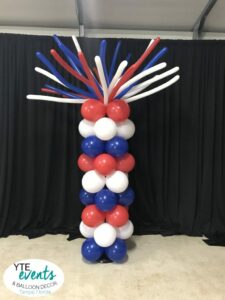 Starburst firecracker top on red white blue fourth of july patriotic themed balloon column