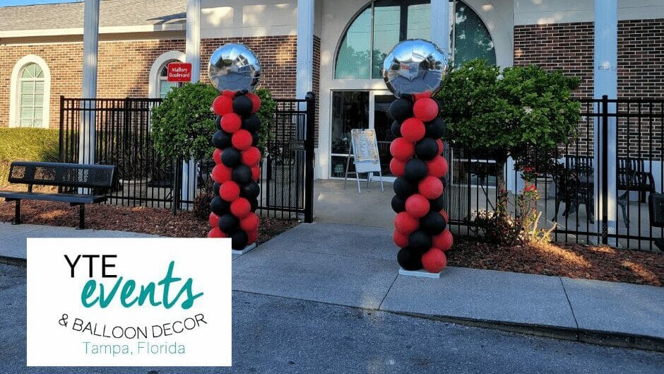 Tampa day school graduation with red and black quick spiral columns and foil toppers.