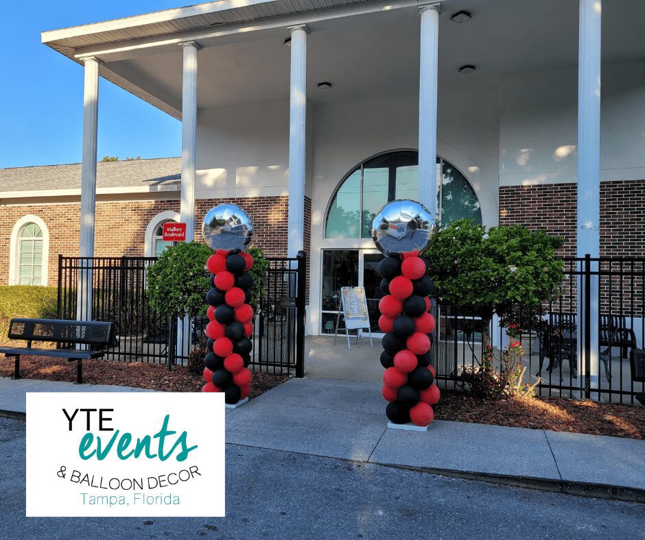 Tampa day school graduation with red and black quick spiral columns and foil toppers.