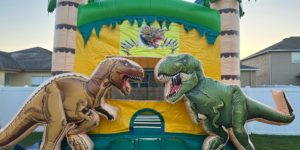Trex Dinosaur bounce house with palm trees