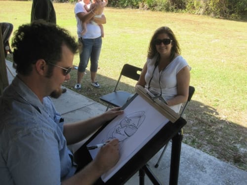 Trey drawing caricature art at a birthday party 1