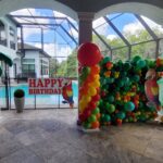 Tropical Parrot Themed Balloon Birthday Party Decor with Wall and Palm Trees