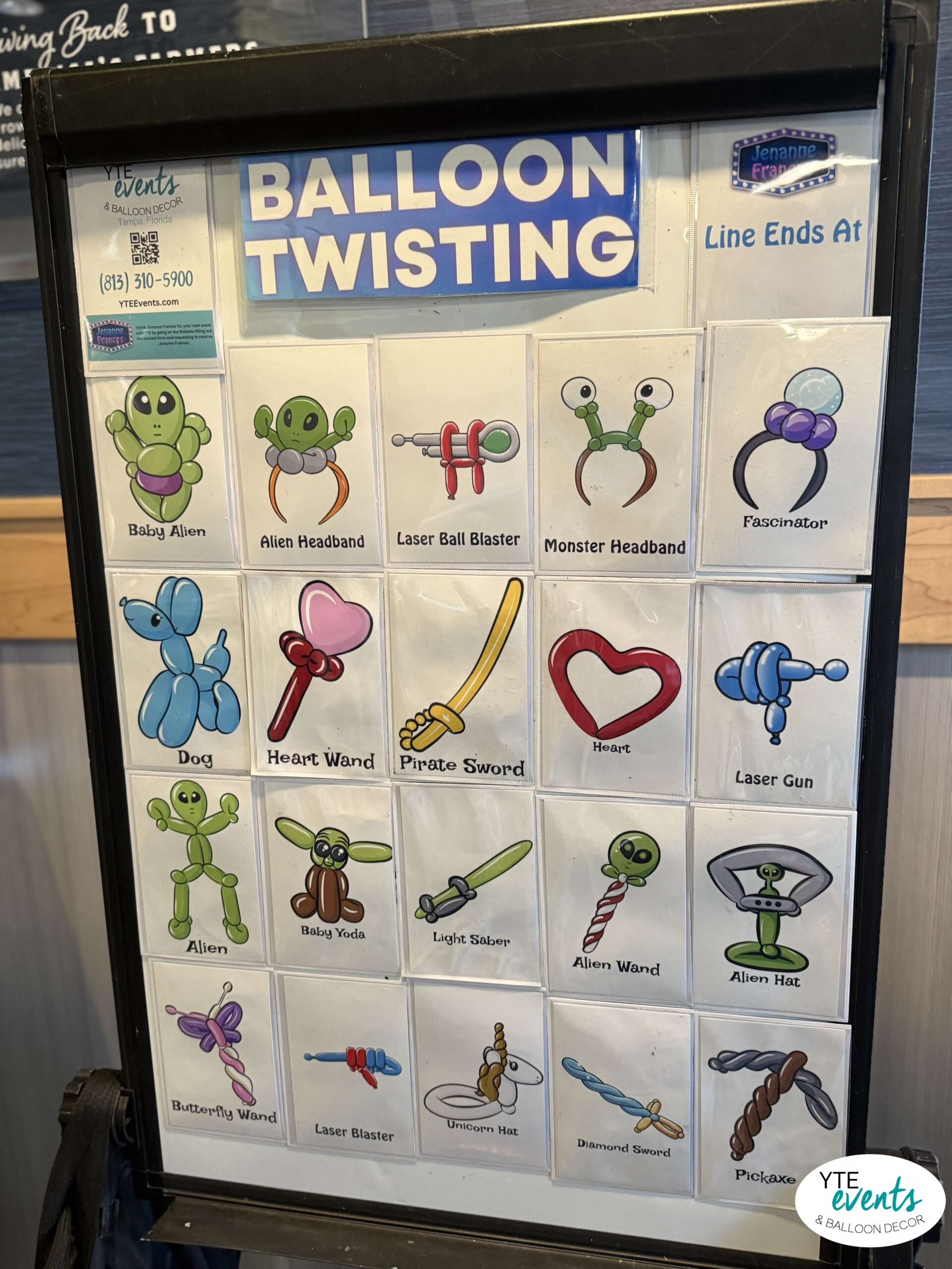 Menu board displaying various colorful balloon twisting designs including aliens, swords, animals, and headbands for kids events