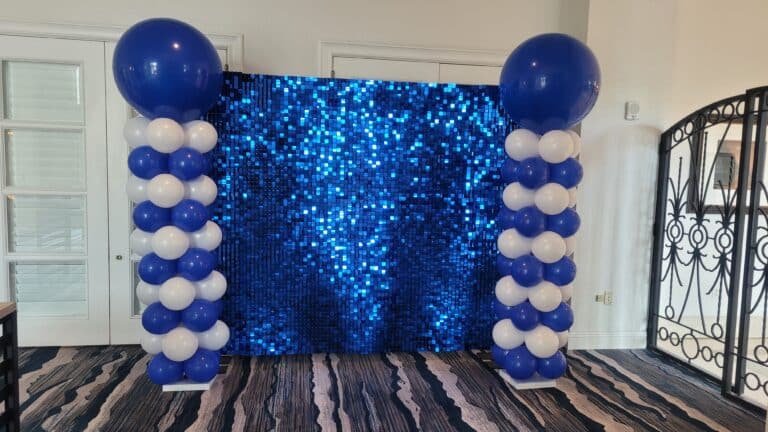 Blue Shimmer Wall Backdrop and Balloon Columns: The Perfect Decor for Corporate Events