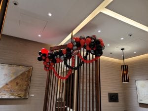 close up of balloon decor in jewelry store balloon installation in international mall with red black silver and foil football accents scaled
