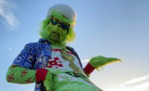 The Grinch enjoying the Florida weather on the beach wearing island clothes