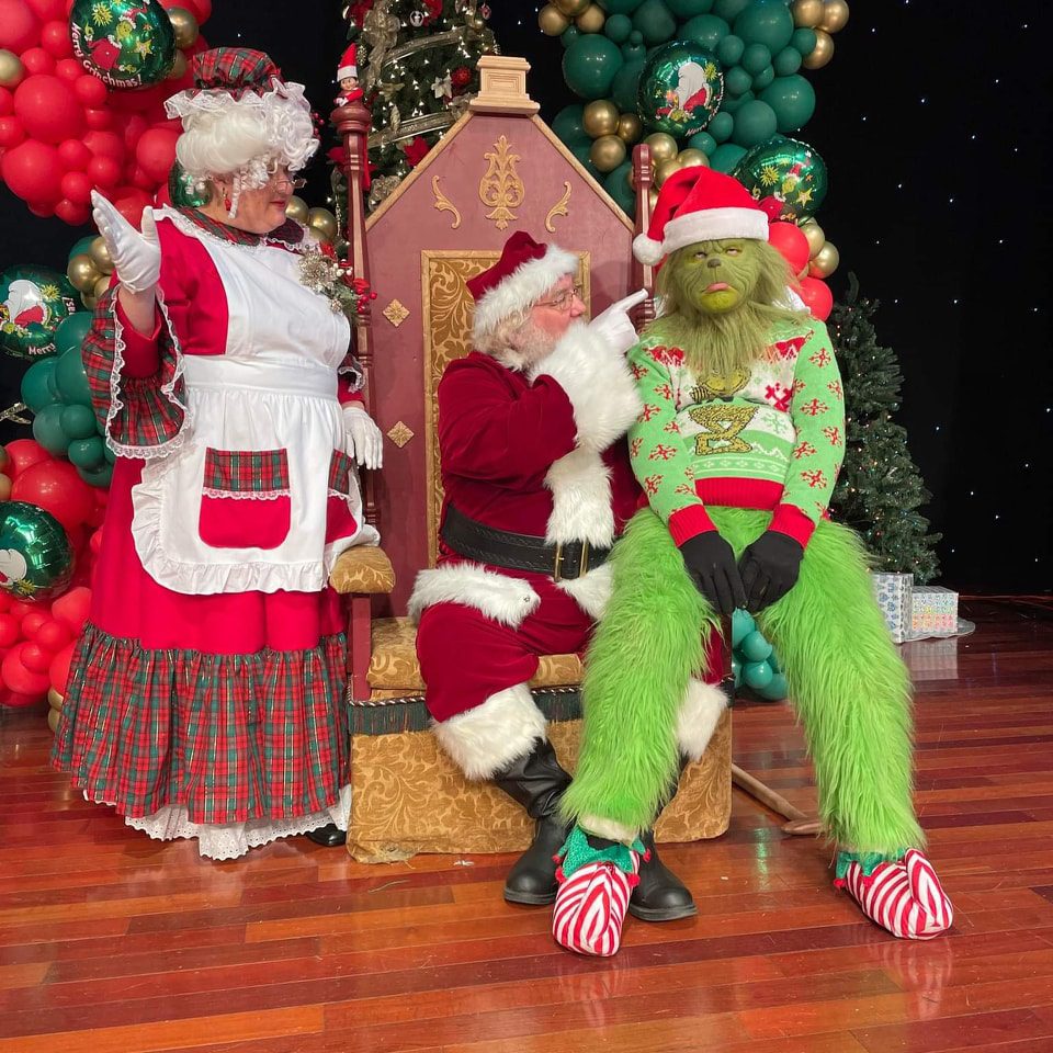 Santa and mrs claus having a talk with the Grinch