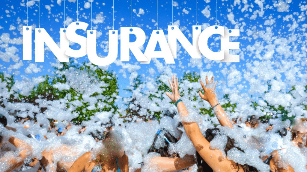 Shows a group of people at a foam party being covered in foam with the word "Insurance" at the top of the photo.
