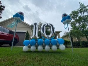 magestic view of yard art display and spirit sticks in front lawn tampa scaled