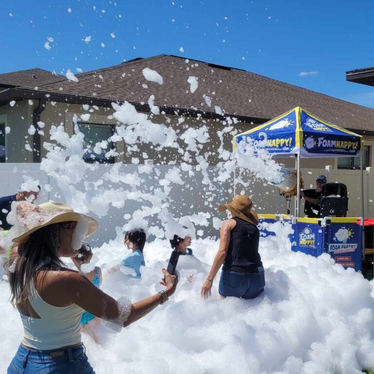 mom taking picture in sea of foam at a foam party on a bright day