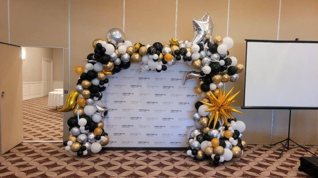 step and repeat backdrop with elegant balloon decor accents