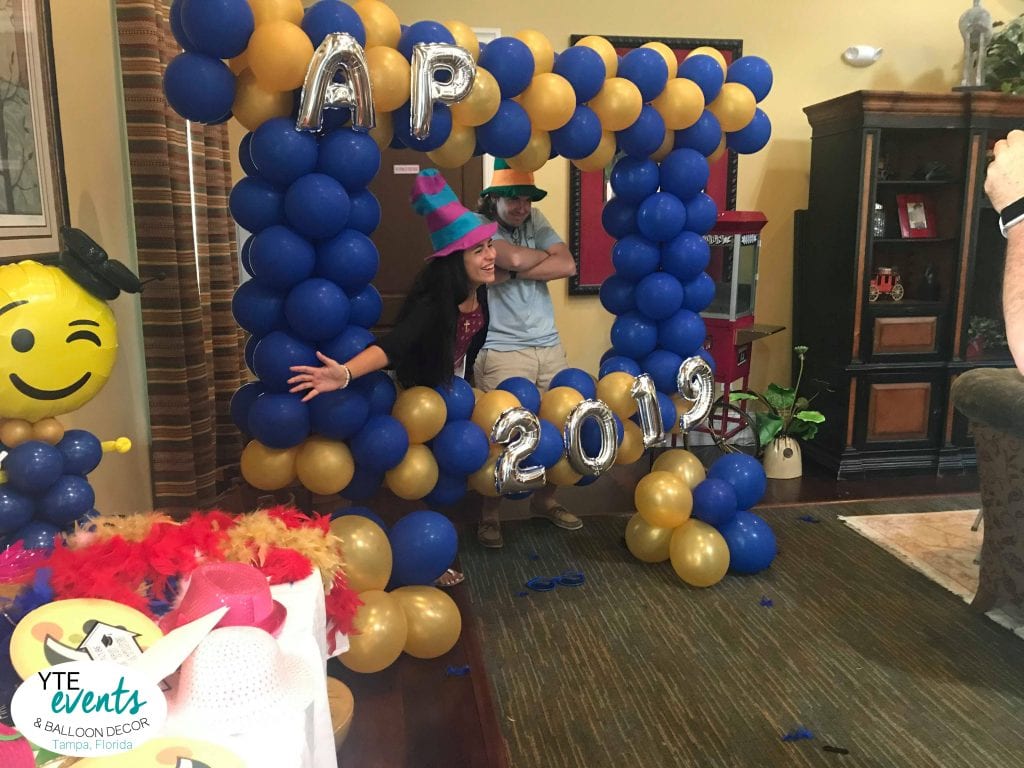 taking photos in the photo opp for 2019 graduation party