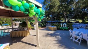 tenth birthday balloons beside food tables in gazebo poolside