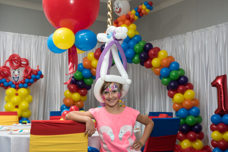 unicorn hat and facepaint little girl balloon decor party