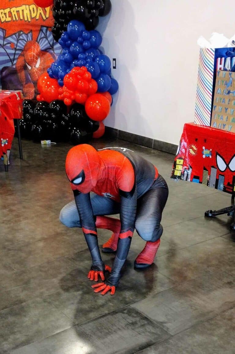 web boy crouching pose blue black and red kids birthday party